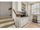 Butler pantry with custom cabinets, sink, and stairs at 8 W Andrews Nw Dr, Atlanta, GA 30305