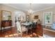 Formal dining room with chandelier, patterned floors, and ample natural light at 8 W Andrews Nw Dr, Atlanta, GA 30305