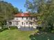 Elegant two-story home featuring a landscaped lawn, a stone veranda, and a red tile roof at 8 W Andrews Nw Dr, Atlanta, GA 30305
