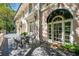 Exterior view of the house showing a patio with wrought iron furniture and an awning at 8 W Andrews Nw Dr, Atlanta, GA 30305