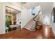 Elegant foyer with staircase, chandelier, and tile and wood flooring at 8 W Andrews Nw Dr, Atlanta, GA 30305
