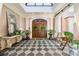 Welcoming foyer with dark wood double doors, checkered floors, and natural light at 8 W Andrews Nw Dr, Atlanta, GA 30305