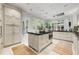 Gourmet kitchen with custom cabinets, stainless steel appliances, a large island, and light filled windows at 8 W Andrews Nw Dr, Atlanta, GA 30305