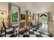 Elegant living room with checkerboard flooring, neutral decor, and large windows providing ample natural light at 8 W Andrews Nw Dr, Atlanta, GA 30305