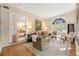 Bright living room with hardwood floors, large arched windows, and a decorative rug at 8 W Andrews Nw Dr, Atlanta, GA 30305