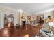 Bright and airy living room with parquet floors, fireplace, and views of the entry and dining room at 8 W Andrews Nw Dr, Atlanta, GA 30305
