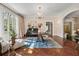 Elegant living room featuring hardwood floors, a chandelier, and views of the backyard at 8 W Andrews Nw Dr, Atlanta, GA 30305