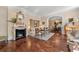 Elegant living room with fireplace, beautiful hardwood floors, and an arched doorway to the dining room at 8 W Andrews Nw Dr, Atlanta, GA 30305