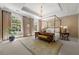 A beautifully appointed primary bedroom with a four-poster bed, natural light, and a plush rug at 8 W Andrews Nw Dr, Atlanta, GA 30305