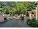Outdoor patio featuring a built-in kitchen, dining area, a pool, and beautiful landscaping at 8 W Andrews Nw Dr, Atlanta, GA 30305