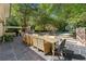 Outdoor patio with a dining area, pool, lush landscaping, and a serene backyard view at 8 W Andrews Nw Dr, Atlanta, GA 30305