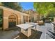 Backyard patio features an outdoor kitchen, dining area, and a ping pong table for outdoor fun at 8 W Andrews Nw Dr, Atlanta, GA 30305