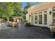 Spacious outdoor patio with a built-in kitchen, dining area, and lush landscaping at 8 W Andrews Nw Dr, Atlanta, GA 30305