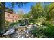 A backyard oasis with a soothing pond and waterfall, creating a tranquil retreat at 8 W Andrews Nw Dr, Atlanta, GA 30305