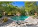 Backyard pool featuring stone coping and lounging areas amid mature trees and landscaping at 8 W Andrews Nw Dr, Atlanta, GA 30305