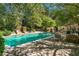 Inviting pool with stone patio, lounge chairs and dining area for relaxing and entertaining at 8 W Andrews Nw Dr, Atlanta, GA 30305