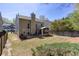 Well-maintained backyard with a screened porch, patio, and mature landscaping at 1037 Dunedin Trl, Woodstock, GA 30188