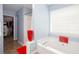 Bathroom with a soaking tub, tile flooring, and a view of a walk-in closet offering ample space at 1037 Dunedin Trl, Woodstock, GA 30188