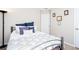 Bedroom with a metal bed frame, plush bedding, and neutral tones, perfect for restful sleep at 1037 Dunedin Trl, Woodstock, GA 30188