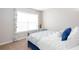 Cozy bedroom featuring a metal bed frame, white linens, and bright natural light from the window at 1037 Dunedin Trl, Woodstock, GA 30188