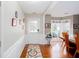 Inviting foyer with hardwood floors, white wainscoting, and a view into the dining room at 1037 Dunedin Trl, Woodstock, GA 30188