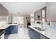 Open kitchen design with a breakfast bar, stone countertops, stainless appliances, and a sliding patio door at 1037 Dunedin Trl, Woodstock, GA 30188