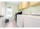 Functional laundry room with a washer, dryer, and built-in shelving for storage at 1037 Dunedin Trl, Woodstock, GA 30188