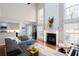 Open-concept living room with fireplace and adjacent kitchen, perfect for entertaining at 1037 Dunedin Trl, Woodstock, GA 30188
