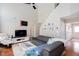 Bright living room showcasing hardwood floors, vaulted ceilings, and comfortable seating at 1037 Dunedin Trl, Woodstock, GA 30188