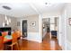 Dining room showing open floor plan with hardwood floors flowing into the living space at 1037 Dunedin Trl, Woodstock, GA 30188