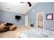 Bright bedroom with vaulted ceilings, a ceiling fan, and neutral carpet with view to en suite bathroom at 1037 Dunedin Trl, Woodstock, GA 30188