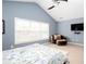 Airy bedroom with vaulted ceilings, a ceiling fan, and neutral carpet with natural light at 1037 Dunedin Trl, Woodstock, GA 30188