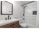 Modern bathroom featuring white subway tile shower and stylish vanity, complemented by sleek black fixtures at 2189 Gordon Se Cir, Smyrna, GA 30080