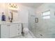Bright bathroom featuring a glass-enclosed shower, marble-style tiling, modern fixtures, and a sleek vanity at 2189 Gordon Se Cir, Smyrna, GA 30080