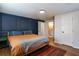 Comfortable bedroom with dark accent wall, hardwood floors, and plenty of closet space at 2189 Gordon Se Cir, Smyrna, GA 30080