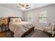 Cozy bedroom with natural light and a ceiling fan, creating a warm and inviting atmosphere for relaxation at 2189 Gordon Se Cir, Smyrna, GA 30080