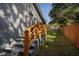 Gray brick home exterior with wooden railing steps leading to a spacious backyard with a white storage shed at 2189 Gordon Se Cir, Smyrna, GA 30080