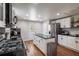 Modern kitchen with stainless steel appliances, central island, and black granite countertops at 2189 Gordon Se Cir, Smyrna, GA 30080