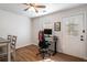 Bright office space with wood floors, ceiling fan, and natural light coming from a window and glass door at 2189 Gordon Se Cir, Smyrna, GA 30080
