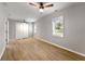 Large bedroom featuring a window, hardwood floors, a ceiling fan and a double door closet at 1027 Garibaldi Sw St, Atlanta, GA 30310