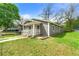 Well-maintained gray duplex with a green lawn and mature trees on a sunny day at 1027 Garibaldi Sw St, Atlanta, GA 30310