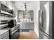Modern kitchen with stainless steel appliances, gray cabinets, and subway tile backsplash at 1027 Garibaldi Sw St, Atlanta, GA 30310