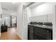 Laundry area with side-by-side washer and dryer, plus storage shelves and a door to the outside at 1027 Garibaldi Sw St, Atlanta, GA 30310