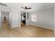 Open-concept room with hardwood floors, white walls and ceiling fan at 1027 Garibaldi Sw St, Atlanta, GA 30310