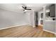 Bright, open-concept living room with hardwood floors, white walls and a modern kitchen in view at 1027 Garibaldi Sw St, Atlanta, GA 30310