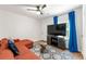 Cozy living room with a orange sectional sofa, ceiling fan and a flat screen television over a console at 1027 Garibaldi Sw St, Atlanta, GA 30310