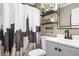 Modern bathroom featuring a vanity with sleek fixtures, decorative shelves, and a unique shower curtain at 1257 Lyle Pl, Atlanta, GA 30318