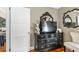 Bedroom with an elegant black dresser, ornate mirror, and a comfortable upholstered chair at 1257 Lyle Pl, Atlanta, GA 30318