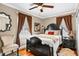 Charming bedroom with hardwood floors, ceiling fan, and a decorative black wood frame bed at 1257 Lyle Pl, Atlanta, GA 30318