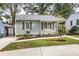 Charming one-story home featuring gray siding, updated windows, a manicured lawn, and a sidewalk at 1257 Lyle Pl, Atlanta, GA 30318